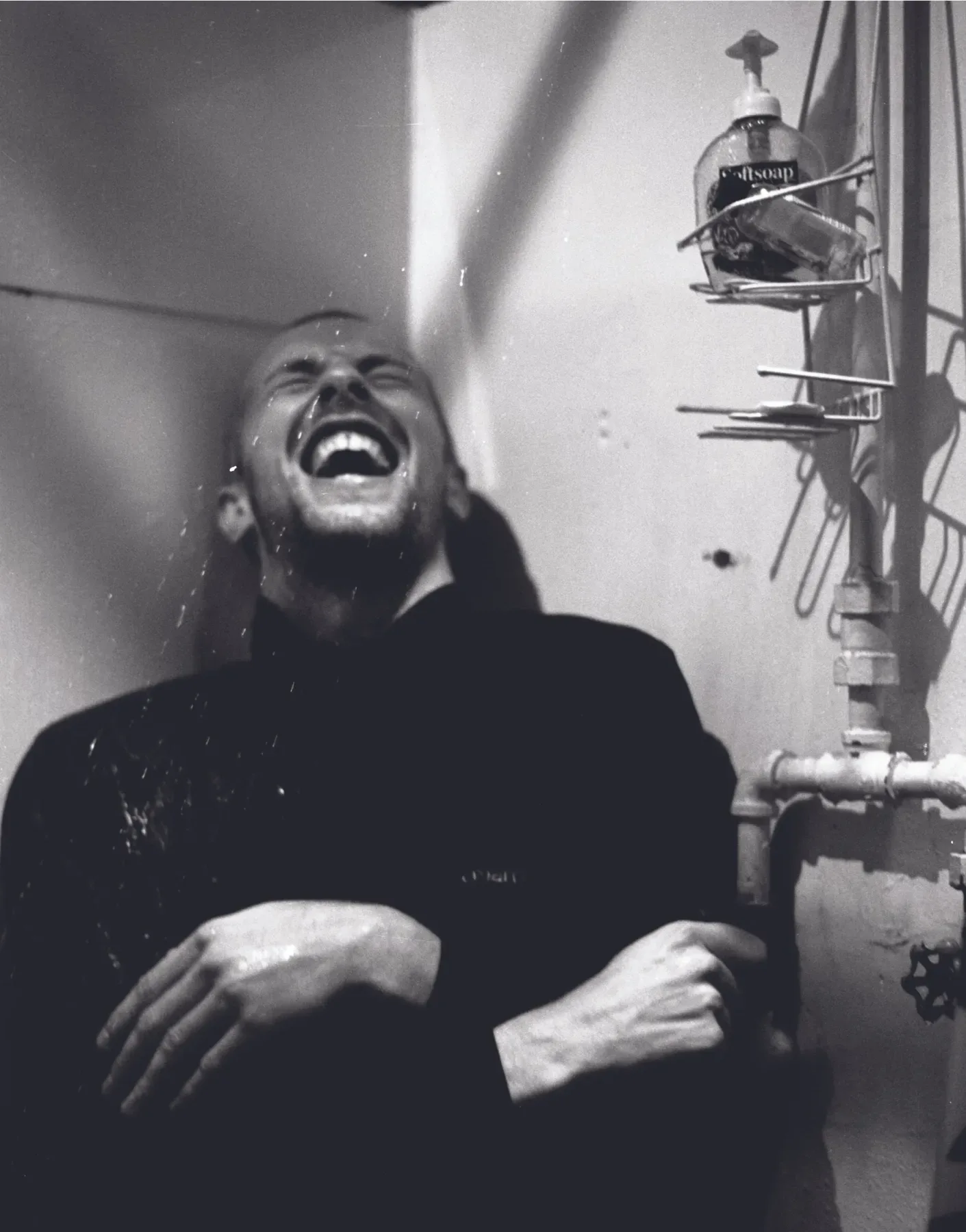 Black and white photograph of Chris Martin laughing